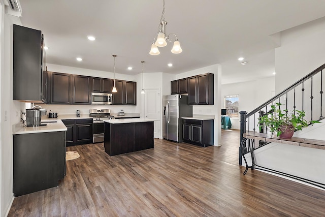 kitchen with light countertops, a center island, dark wood-style floors, and stainless steel appliances