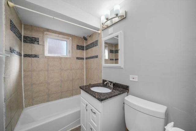 bathroom featuring vanity, toilet, and tub / shower combination