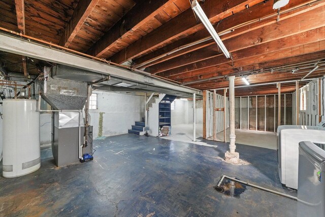 basement with stairway, heating unit, washer / dryer, and water heater