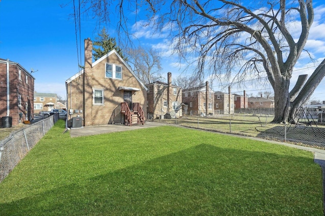 exterior space featuring a residential view, central AC unit, and a fenced backyard