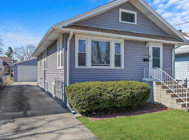 view of front of house with an outbuilding, fence, and a garage