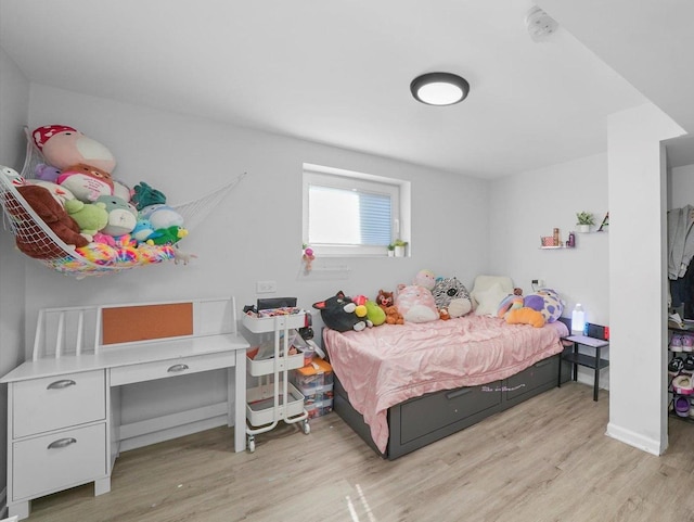 bedroom with light wood finished floors