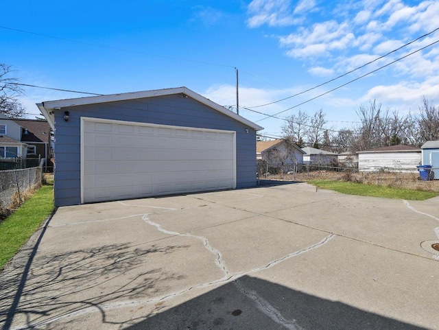 detached garage featuring fence