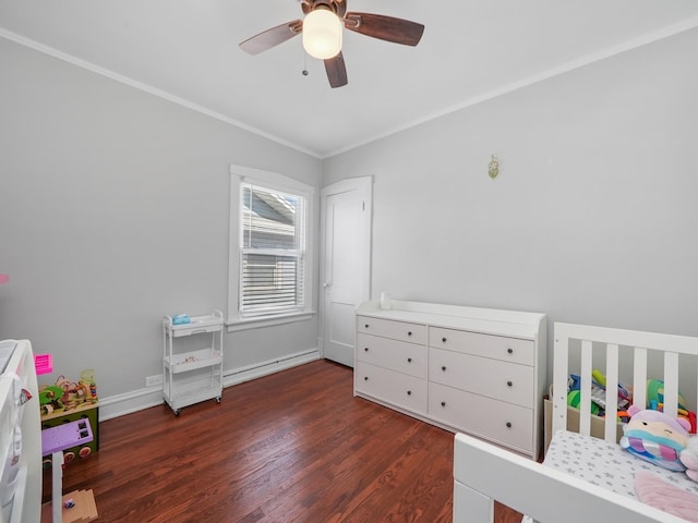 bedroom with a crib, ornamental molding, a ceiling fan, wood finished floors, and baseboards