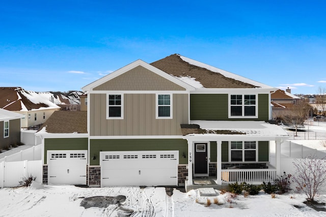 view of front of house featuring a garage, stone siding, a porch, and fence