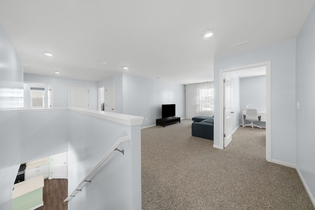 hall featuring an upstairs landing, recessed lighting, baseboards, and carpet floors