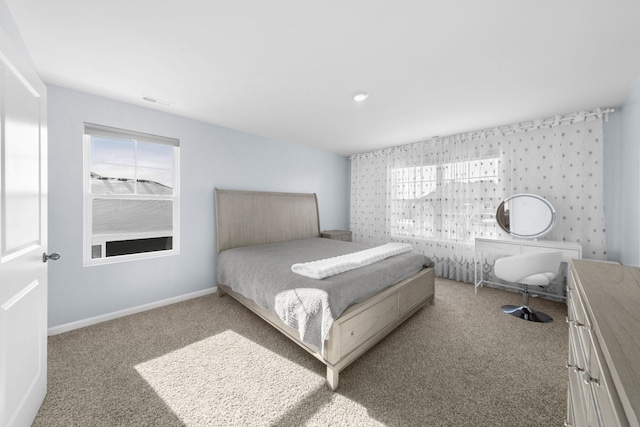 bedroom featuring baseboards, carpet floors, and visible vents