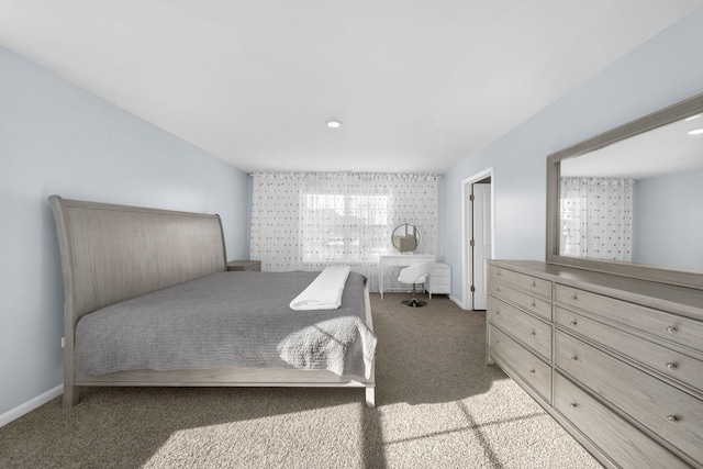 bedroom with light carpet and baseboards