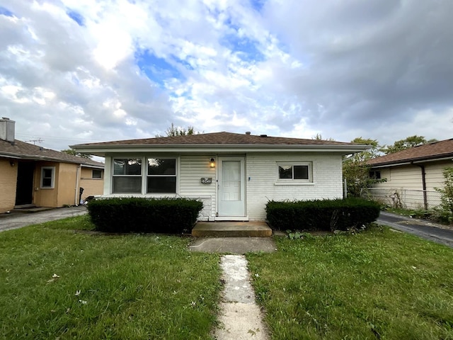 view of front of house with brick siding and a front yard