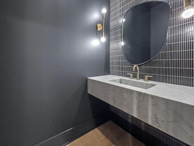 bathroom featuring tasteful backsplash and a sink