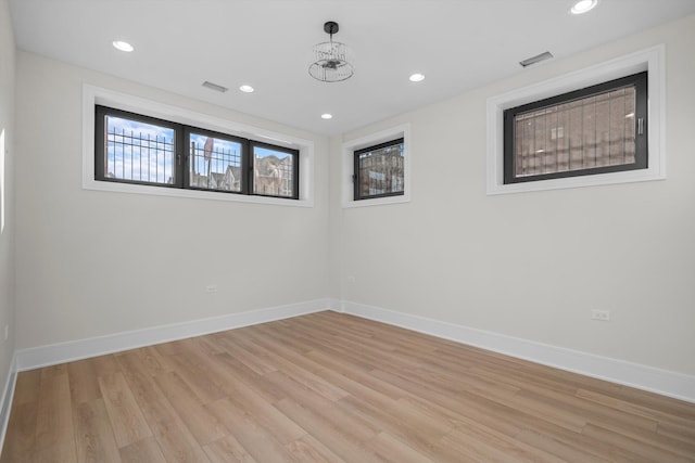 empty room with recessed lighting, visible vents, baseboards, and light wood-style floors