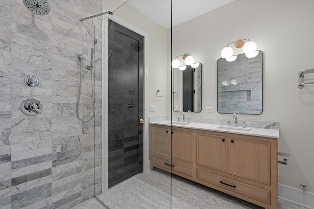 bathroom featuring a sink, tiled shower, and double vanity