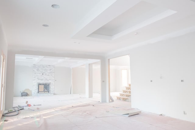 unfurnished living room with a fireplace and stairs
