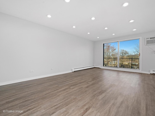 unfurnished room featuring recessed lighting, baseboards, baseboard heating, and wood finished floors