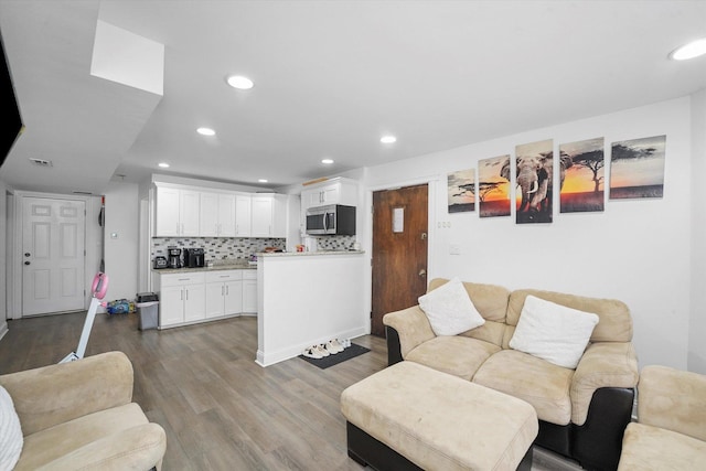 living room featuring recessed lighting and wood finished floors