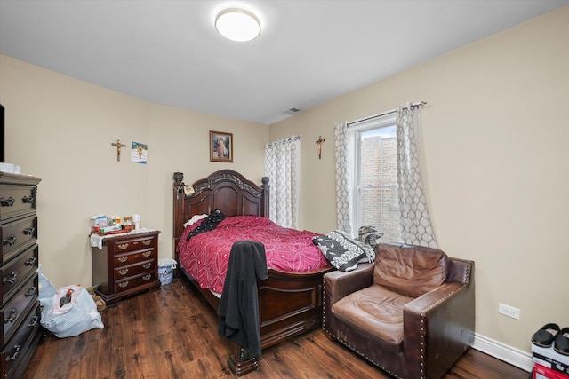 bedroom with visible vents, dark wood-style floors, and baseboards