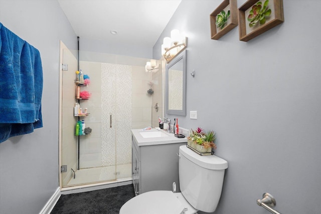 bathroom featuring a stall shower, toilet, and vanity