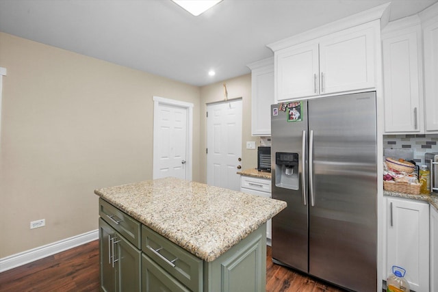 kitchen with backsplash, green cabinetry, white cabinets, and stainless steel fridge with ice dispenser