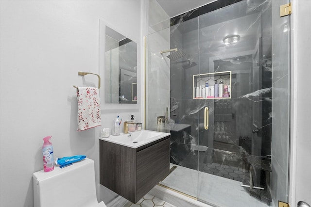 full bathroom with vanity, a shower stall, and toilet