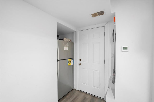 doorway featuring visible vents and dark wood finished floors