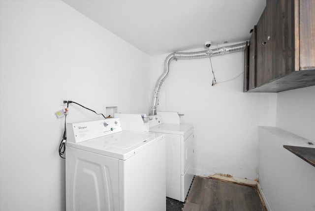 laundry area featuring washing machine and clothes dryer and cabinet space