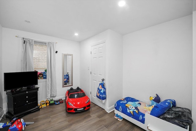 bedroom with recessed lighting and wood finished floors