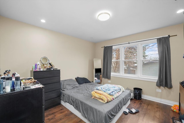 bedroom with recessed lighting, wood finished floors, and baseboards