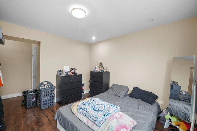 bedroom with wood finished floors and baseboards