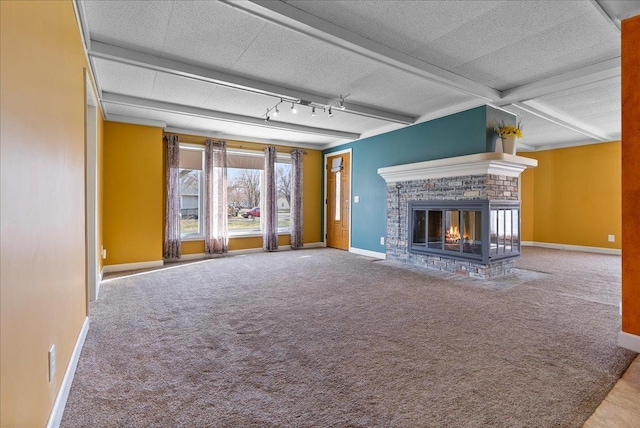 400 S 2nd St, Wapella, IL 61777 - unfurnished living room featuring carpet floors, a brick fireplace, baseboards, beamed ceiling, and a textured ceiling