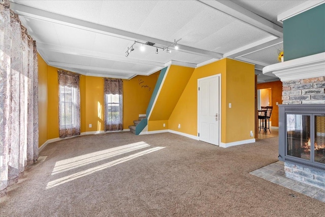 400 S 2nd St, Wapella, IL 61777 - unfurnished living room featuring carpet floors, stairs, baseboards, and track lighting