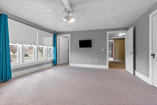 400 S 2nd St, Wapella, IL 61777 - unfurnished room featuring carpet, a ceiling fan, a textured ceiling, and baseboards
