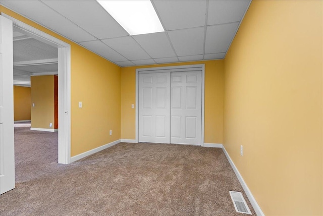 400 S 2nd St, Wapella, IL 61777 - unfurnished bedroom with carpet floors, a closet, a paneled ceiling, and baseboards