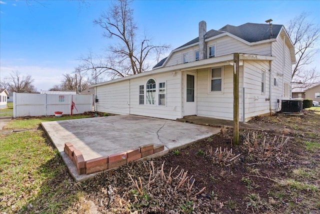 400 S 2nd St, Wapella, IL 61777 - rear view of property featuring central AC unit and a patio