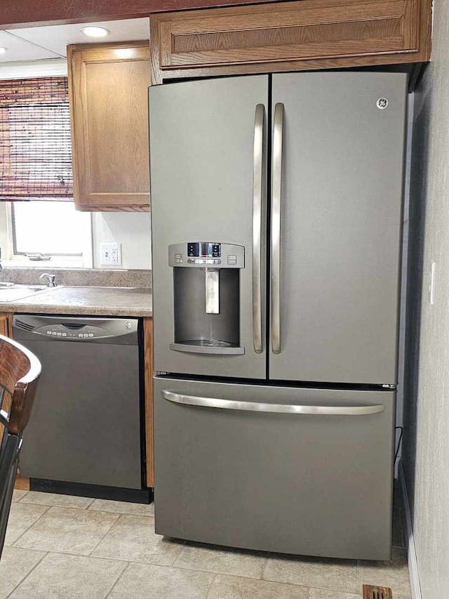 400 S 2nd St, Wapella, IL 61777 - kitchen with stainless steel fridge with ice dispenser, black dishwasher, a sink, and brown cabinetry