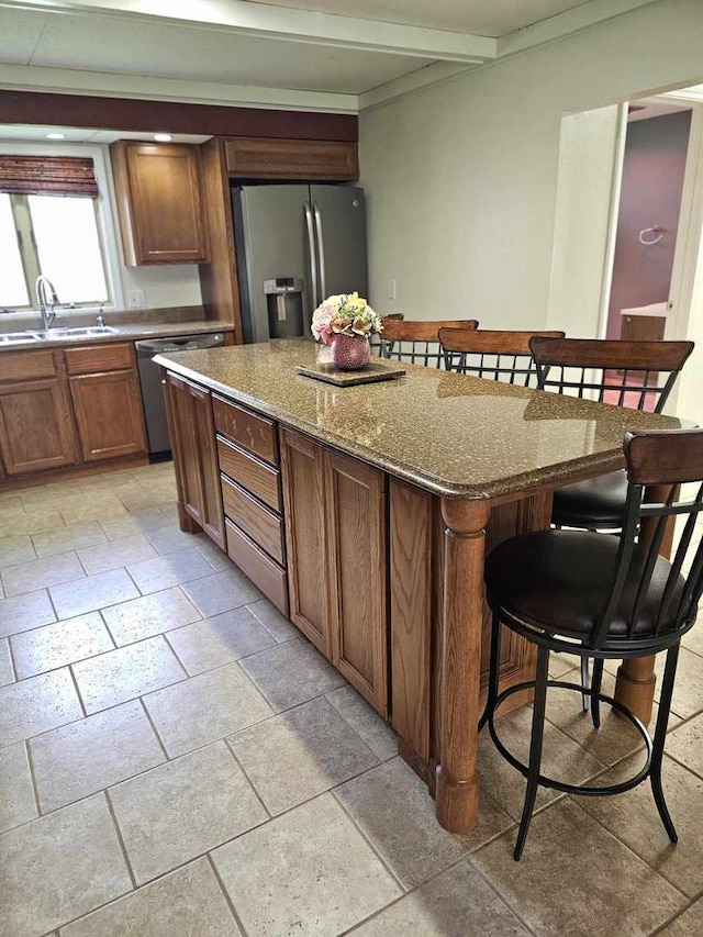 400 S 2nd St, Wapella, IL 61777 - kitchen with stainless steel appliances, a sink, a kitchen breakfast bar, a center island, and stone tile flooring