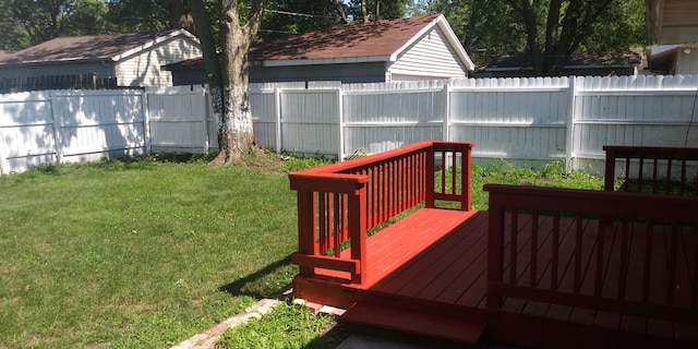 wooden deck with a lawn and fence