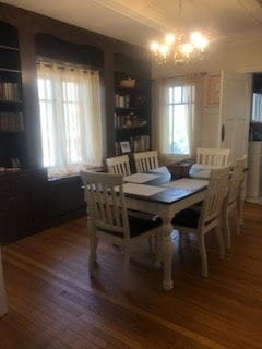 dining area featuring wood finished floors and a chandelier