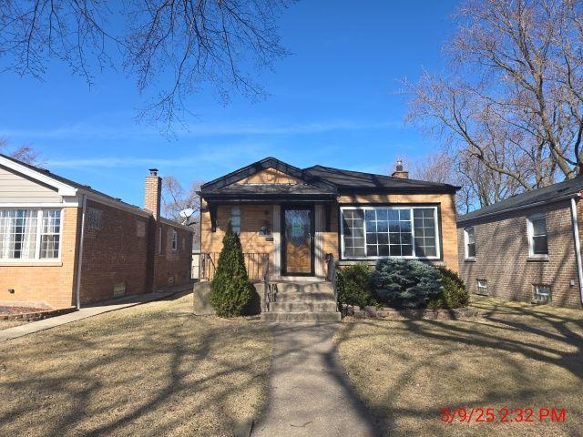 bungalow featuring a chimney