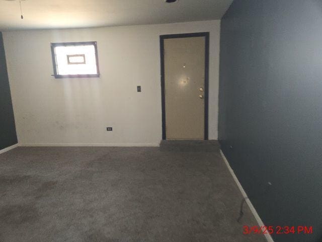 carpeted spare room with baseboards