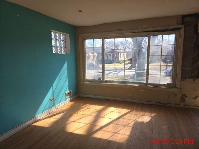 empty room with baseboards and light wood-style floors