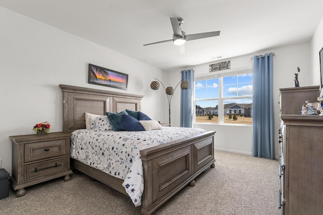 bedroom with baseboards, light colored carpet, and a ceiling fan