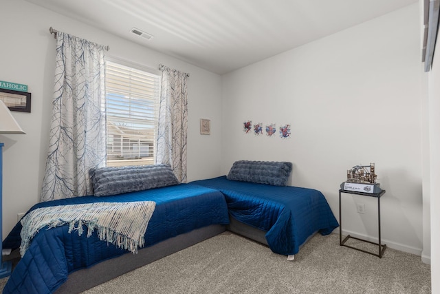 bedroom with visible vents, baseboards, and carpet