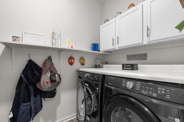 washroom featuring cabinet space and independent washer and dryer