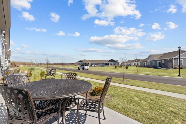 view of patio with a residential view and outdoor dining space