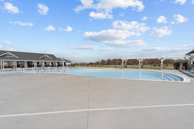 pool featuring a patio and fence