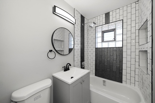 bathroom featuring vanity, toilet, and washtub / shower combination