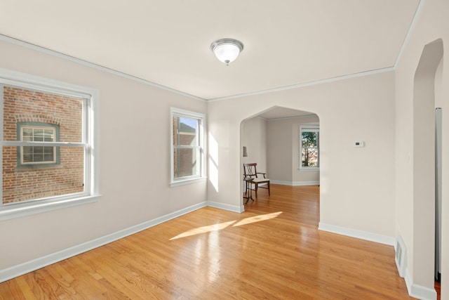 3119 W 83rd St, Chicago, IL 60652 - empty room with arched walkways, light wood-style flooring, baseboards, and ornamental molding