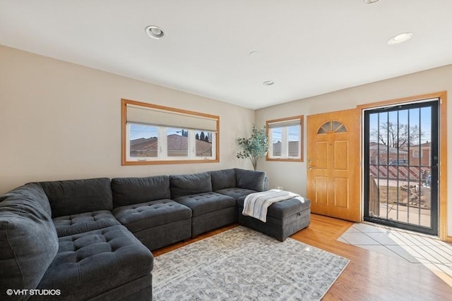 living room with plenty of natural light, recessed lighting, and light wood-type flooring