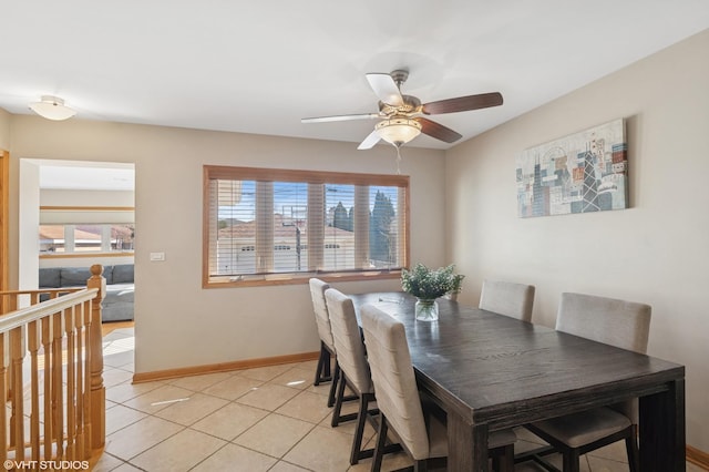 dining room with light tile patterned floors, a ceiling fan, and baseboards