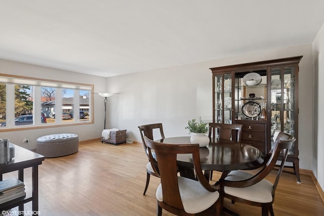 dining room with baseboards and wood finished floors